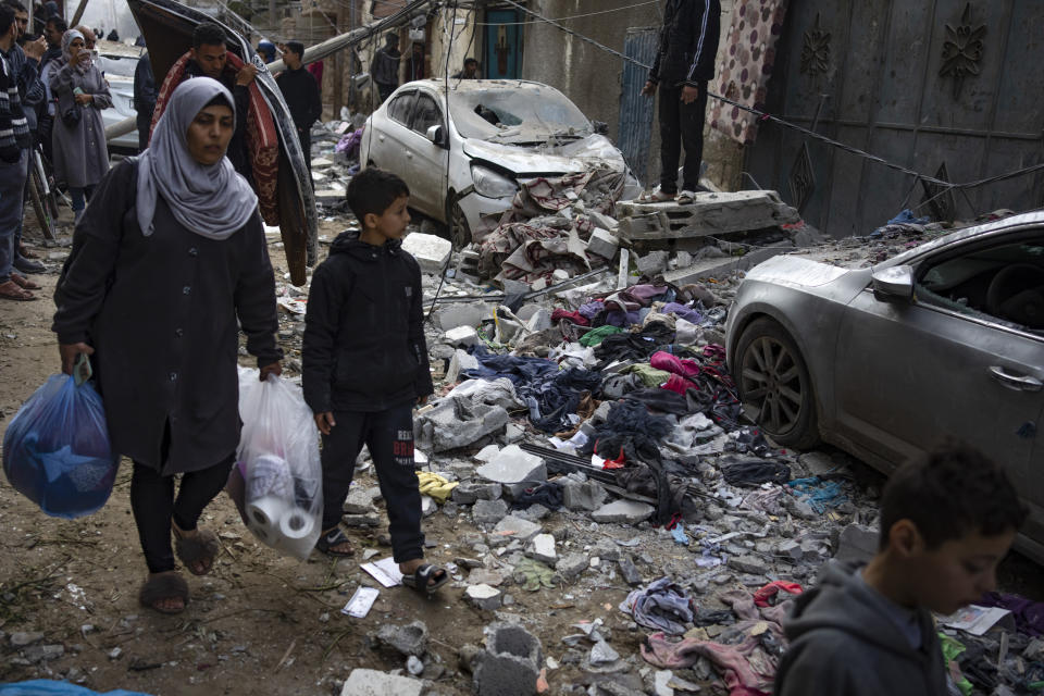 Palestinians look at the destruction after an Israeli airstrike in Rafah, Gaza Strip, Friday, Feb. 9, 2024. (AP Photo/Fatima Shbair)