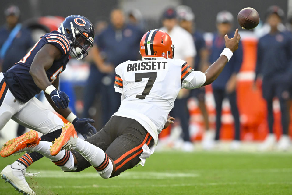 Cleveland Browns quarterback Jacoby Brissett (7) leaps as he gets a pass away in front of Chicago Bears linebacker Nicholas Morrow (53) during the first half of an NFL preseason football game, Saturday, Aug. 27, 2022, in Cleveland. (AP Photo/David Richard)