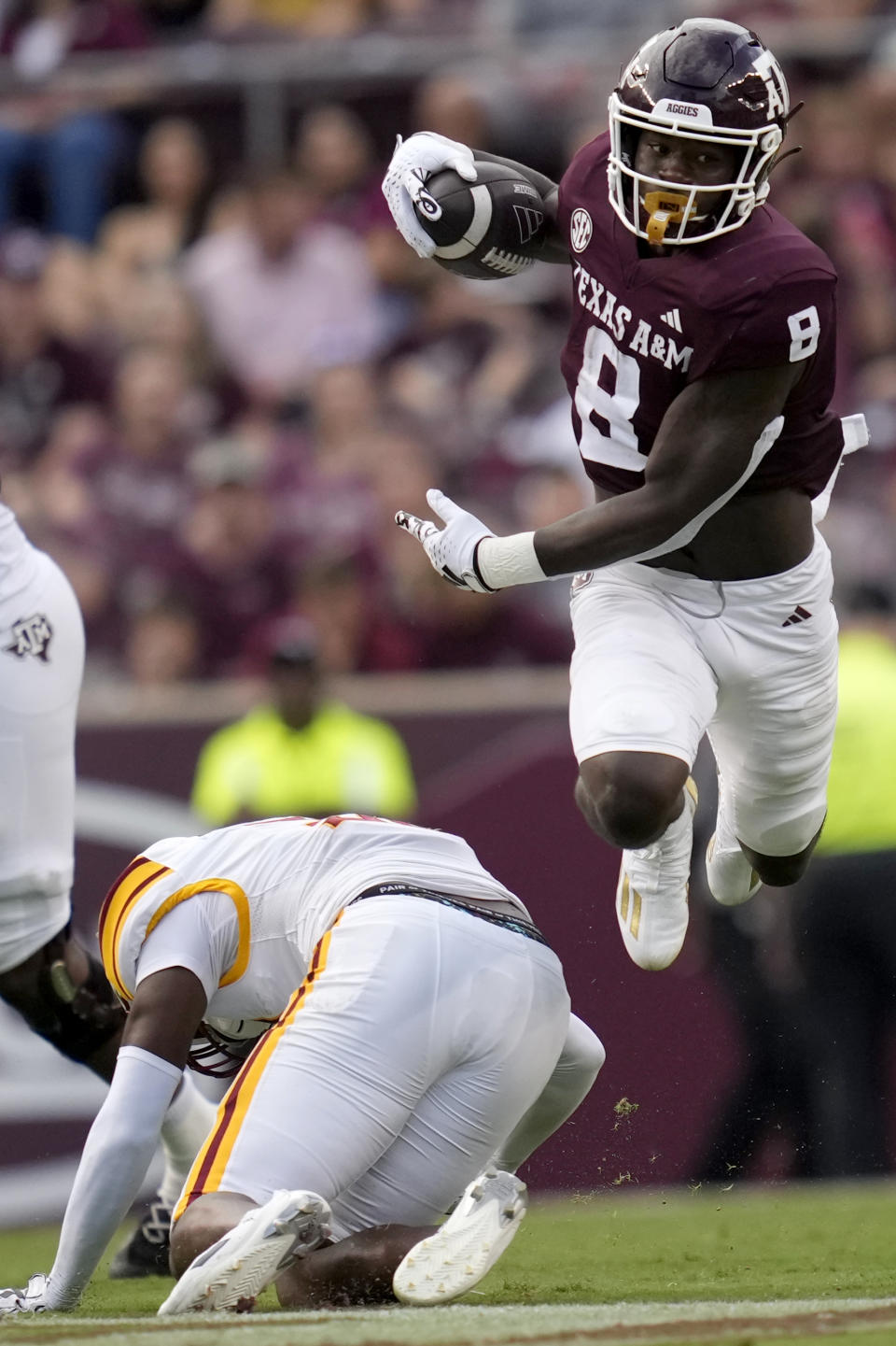 Texas A&M running back Le'Veon Moss (8) jumps over Louisiana-Monroe safety Antwone Watts while picking up a first down on a run during the second half of an NCAA college football game Saturday, Sept. 16, 2023, in College Station, Texas. (AP Photo/Sam Craft)