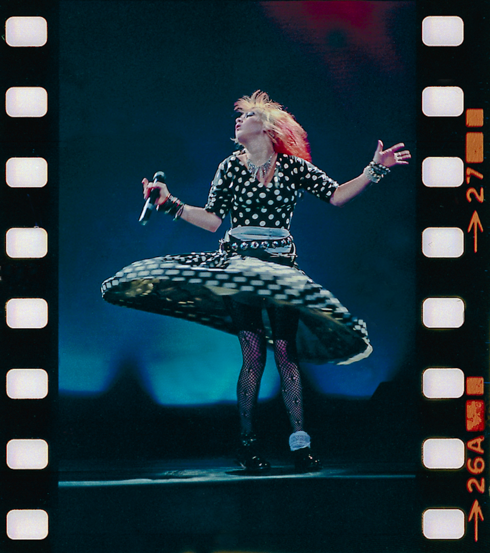 Cyndi Lauper twirls in a polka dot dress.