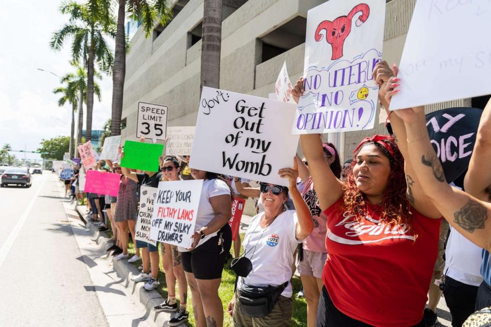 PHOTO: Abortion rights activists hold signs at a protest in support of abortion access, March To Roe The Vote And Send A Message To Florida Politicians That Abortion Access Must Be Protected And Defended, July 13, 2022, in Fort Lauderdale, Fla. (John Parra/Getty Images for MoveOn)