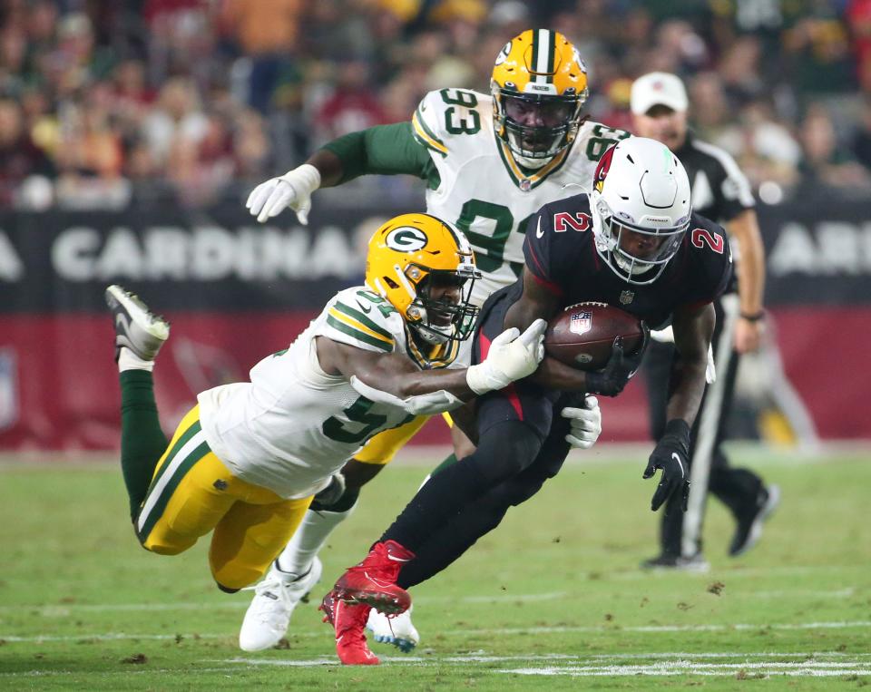 Arizona Cardinals running back Chase Edmonds (2) is tackled by Green Bay Packers linebacker Krys Barnes (51) after a catch during the third quarter in Glendale, Ariz. Oct. 28, 2021.