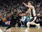 Boston Celtics' Kyrie Irving drives on Indiana Pacers' Domantas Sabonisn during the second quarter in Game 1 of a first-round NBA basketball playoff series, Sunday, April 14, 2019, in Boston. (AP Photo/Winslow Townson)