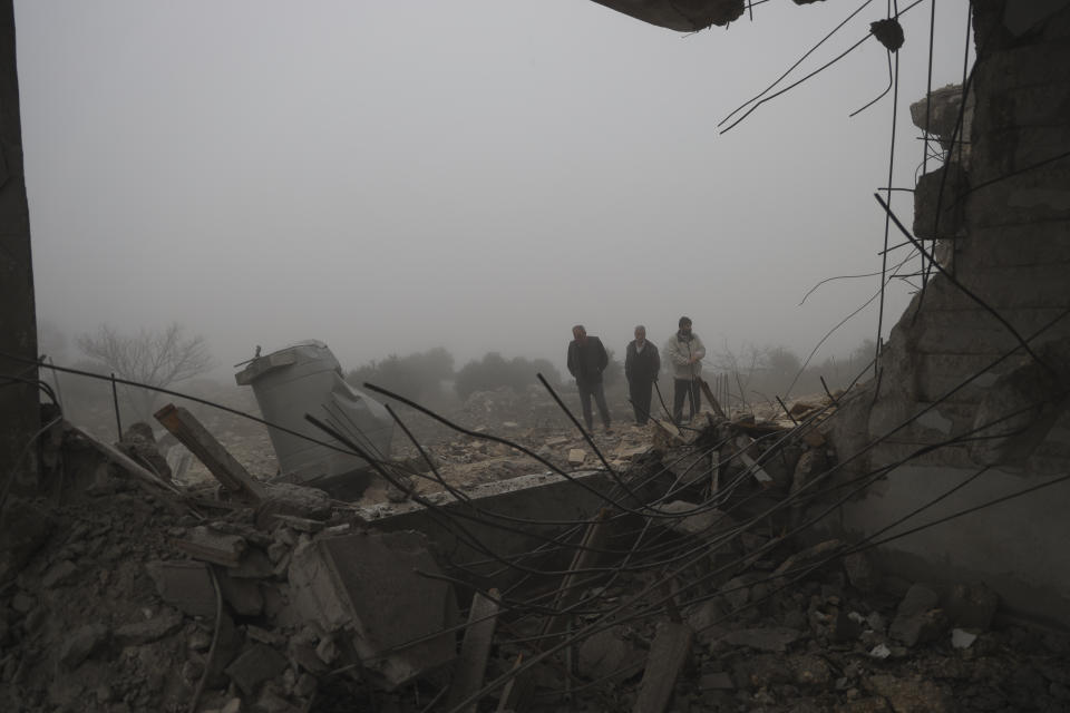 Syrians look at an abandoned medical facility in the village of Talteta, Syria, Tuesday, Jan. 16, 2024, that was hit by Iranian missiles late Monday night, according to a voluntary rescue group White Helmets. Iran fired missiles late Monday at what it claimed was Israeli "spy headquarters" near the U.S. Consulate in the northern Iraqi city of Irbil and at targets linked to the extremist group Islamic State in northern Syria. (AP Photo/Omar Albam)