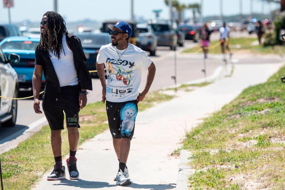 Spring breakers walk along Highway 90 during Black Spring Break in Biloxi on April 13. Pedestrian tape was used along the sidewalks to guide people to crosswalks.