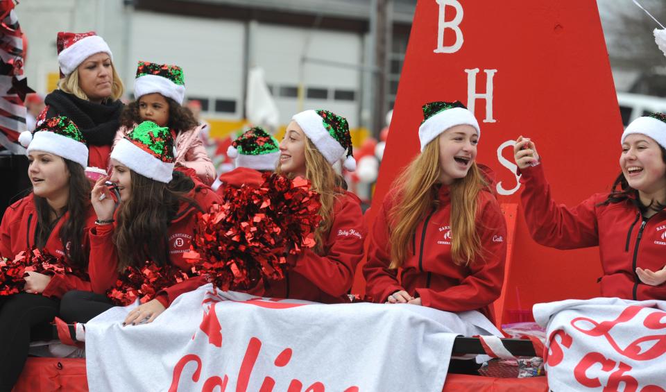 Barnstable High School cheerleaders toss out candy along the route at the Red Raider Rolling Rally in 2019, in advance of the annual Barnstable versus Falmouth Thanksgiving Day game. (Photo: Steve Heaslip/Cape Cod Times)