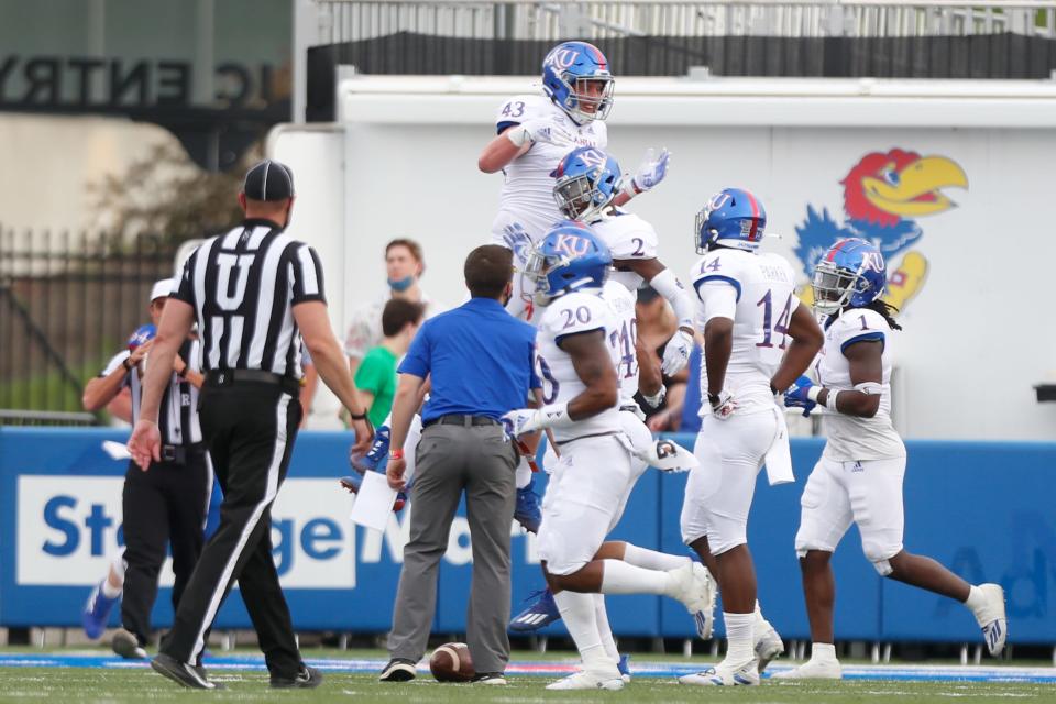 Kansas players celebrate a pick-six by cornerback Cobee Bryant (2) during the spring game scrimmage in 2021.