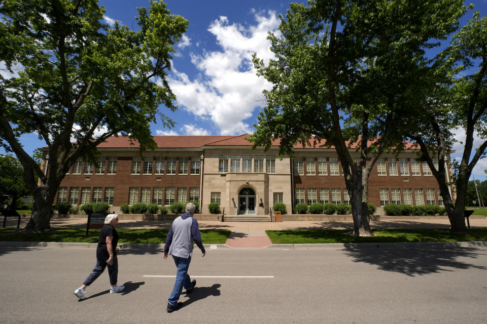 Visitors walk to the former Monroe school, which now houses a national historic site, Friday, May 10, 2024, in Topeka, Kan. The school was at the center of the Brown v. Board of Education Supreme Court ruling ending segregation in public schools 70 years ago. (AP Photo/Charlie Riedel)