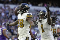 New Orleans Saints running back Latavius Murray (28) celebrates after scoring a touchdown during the third quarter of an NFL match between Minnesota Vikings and New Orleans Saints at the Tottenham Hotspur stadium in London, Sunday, Oct. 2, 2022. (AP Photo/Kirsty Wigglesworth)