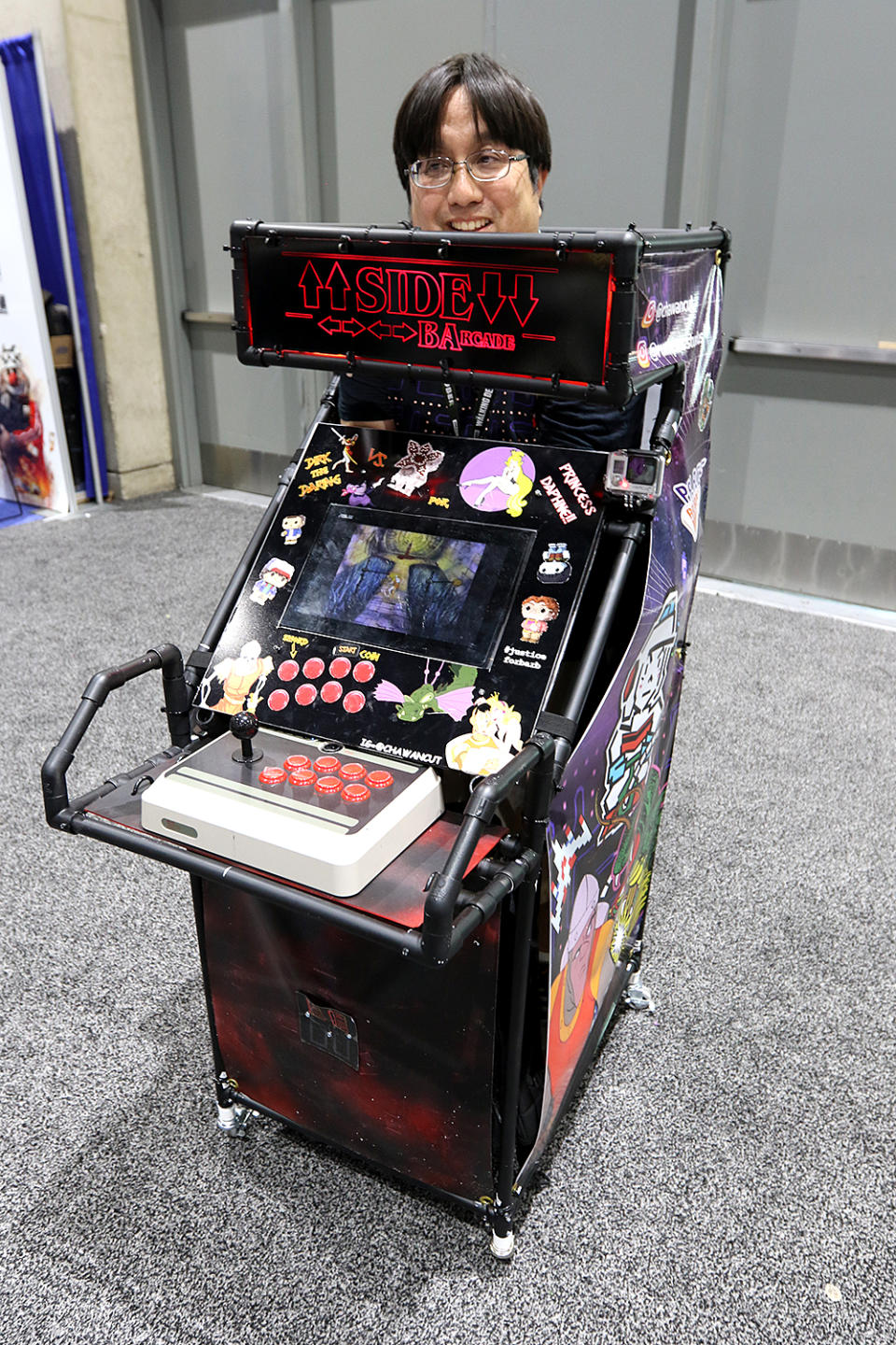 <p>Cosplayer dressed as <em>Dragon’s Lair</em> arcade game from <em>Stranger Things</em> at Comic-Con International on July 20, 2018, in San Diego. <a rel="nofollow" href="https://www.yahoo.com/entertainment/diy-stranger-things-cosplay-costume-stops-crowds-comic-con-015950136.html" data-ylk="slk:Watch footage of Comic-Con attendees interacting with the DIY costume.;elm:context_link;itc:0;sec:content-canvas;outcm:mb_qualified_link;_E:mb_qualified_link;ct:story;" class="link  yahoo-link">Watch footage of Comic-Con attendees interacting with the DIY costume.</a> (Photo: Angela Kim/Yahoo Entertainment) </p>