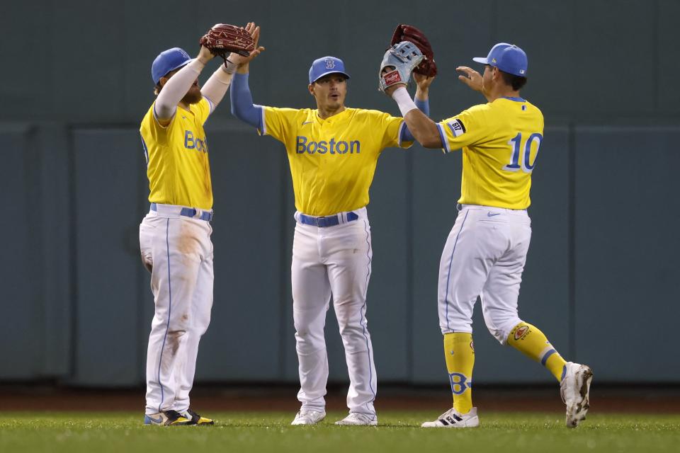 Boston Red Sox outfielders, from left, Alex Verdugo, Enrique Hernandez and Hunter Renfroe celebrate after the Red Sox defeated the Baltimore Orioles in a baseball game Friday, Sept. 17, 2021, in Boston. (AP Photo/Michael Dwyer)