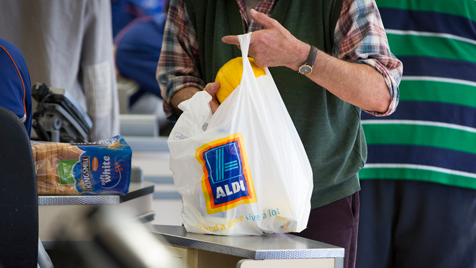 Man packs aldi grocery bag