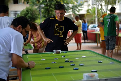 Alexandre Cerqueira Gil, a lawyer and football fan, watches his opponent play during a button football match in Rio de Janeiro