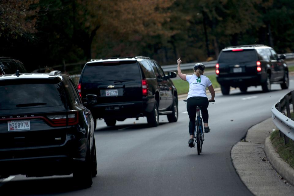 Juli Briskman shows her middle finger as a motorcade with President Donald Trump departs Trump National Golf Course in Sterling, Virginia, in 2017. Two years later, Briskman is on the ballot for local office. (Photo: BRENDAN SMIALOWSKI via Getty Images)