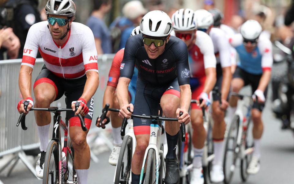 Austria's Marco Haller (L) and Britain's Fred Wright (R) lead a chase group during the men's cycling road race during the Paris 2024 Olympic Games.