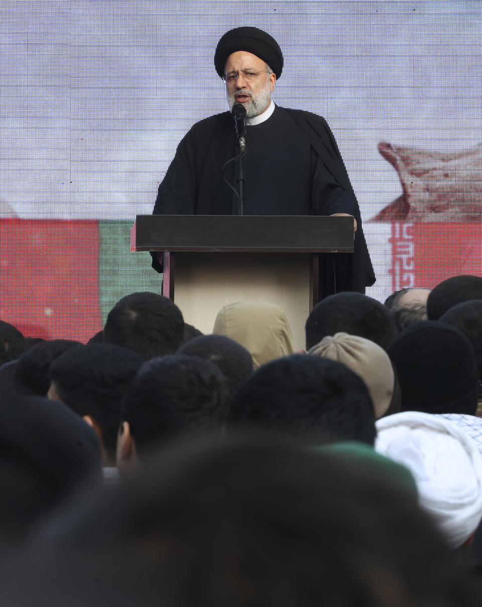 Iranian President Ebrahim Raisi speaks during a funeral procession for a group of unknown Iranian soldiers who were killed during the 1980-88 Iran-Iraq war, whose remains were recently recovered from former battlefields, in Tehran, Iran, Tuesday, Dec. 27, 2022. (AP Photo/Vahid Salemi)