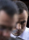 Oscar Pistorius arrives at the high court in Pretoria, South Africa, Friday, April 11, 2014. The chief prosecutor laughed scornfully at an answer from Pistorius during the Olympic athlete's murder trial Thursday, mocking the man who shot his girlfriend. Pistorius is charged with murder for the shooting death of his girlfriend, Reeva Steenkamp, on Valentines Day in 2013. (AP Photo/Themba Hadebe)