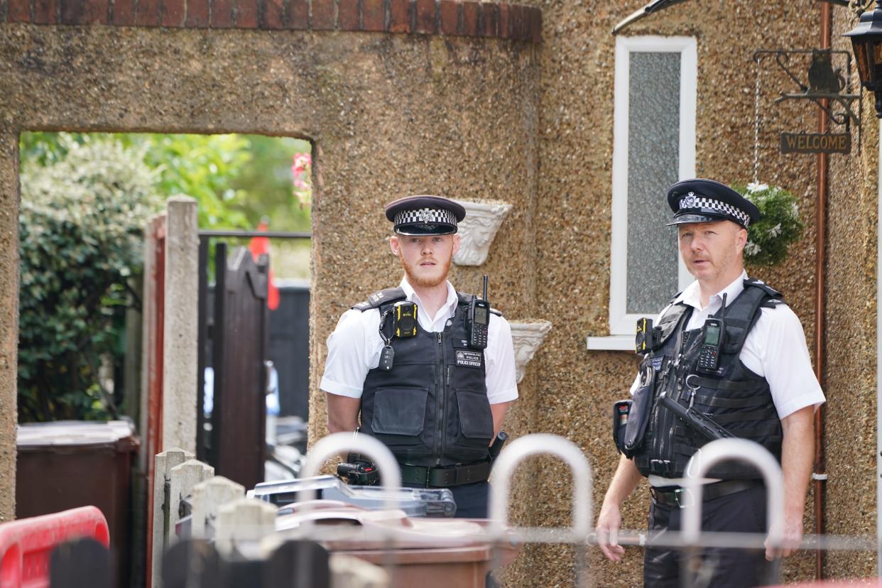 Police at the scene in Hounslow (Lucy North/PA) (PA Wire)