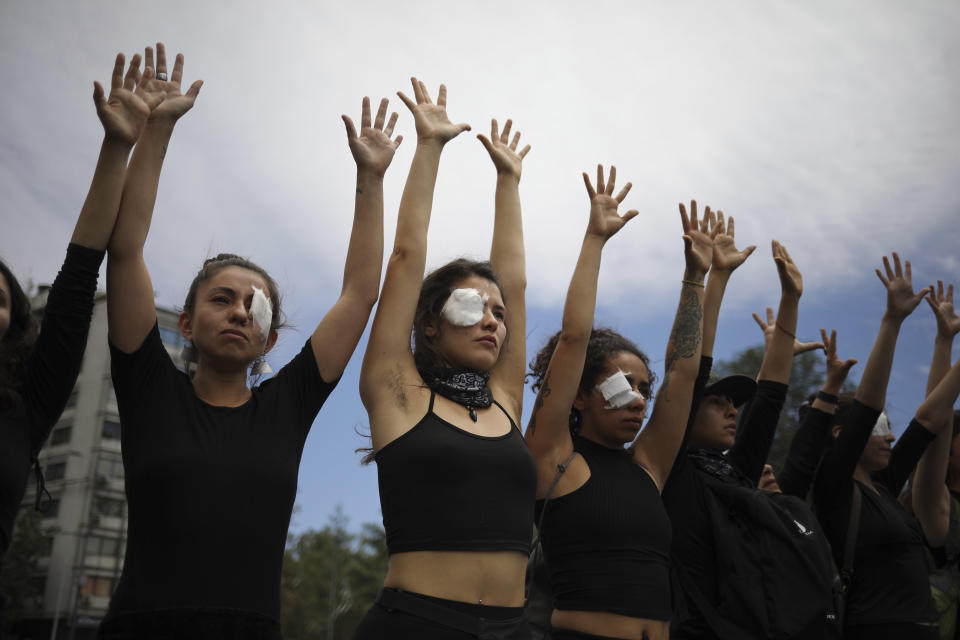 Women dressed in black perform to mourn those who have been killed, tortured and raped during an anti-government protest in Santiago, Chile, Friday, Nov. 1, 2019. Chile has been facing days of unrest, triggered by a relatively minor increase in subway fares. The protests have shaken a nation noted for economic stability over the past decades, which has seen steadily declining poverty despite persistent high rates of inequality. (AP Photo/Rodrigo Abd)