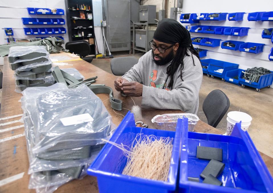 Paradigm Parachute and Defense employee Michael Marks sews a parachute section for a government contract at the company's facility in Escambia County on Nov. 7.