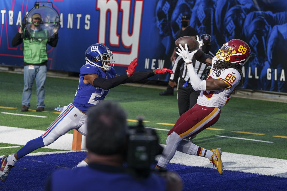 Washington Football Team wide receiver Cam Sims (89) catches a pass for a touchdown in front of New York Giants' Logan Ryan (23) during the second half of an NFL football game Sunday, Oct. 18, 2020, in East Rutherford, N.J. The Giants won 20-19. (AP Photo/John Minchillo)