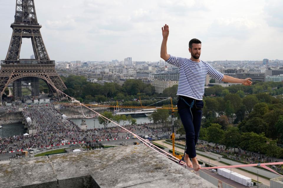 French slackliner Nathan Paulin performs on the second time on a 70-meter-high slackline between the Eiffel Tower and the Chaillot Theater across the Seine River, in Paris Sunday, Sept. 19, 2021.