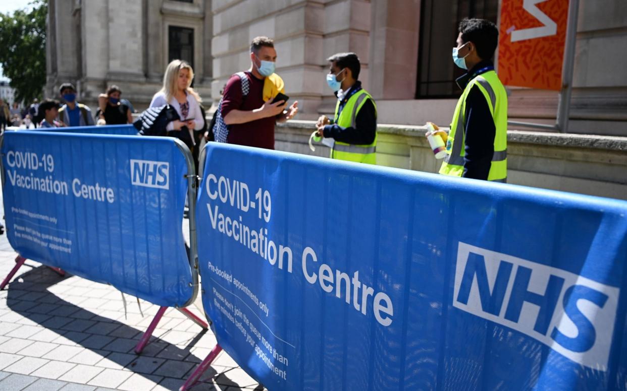People queue at a Covid-19 vaccination centre in London  - Andy Rain/Shutterstock