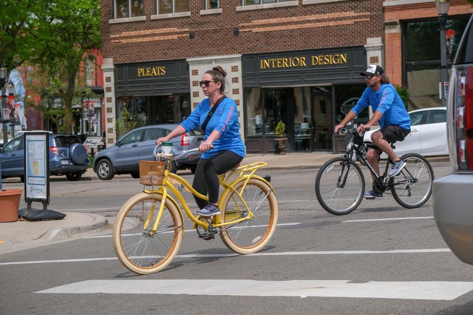 Cyclists ride through Lansing's Old Town Sunday, May 14, 2023.