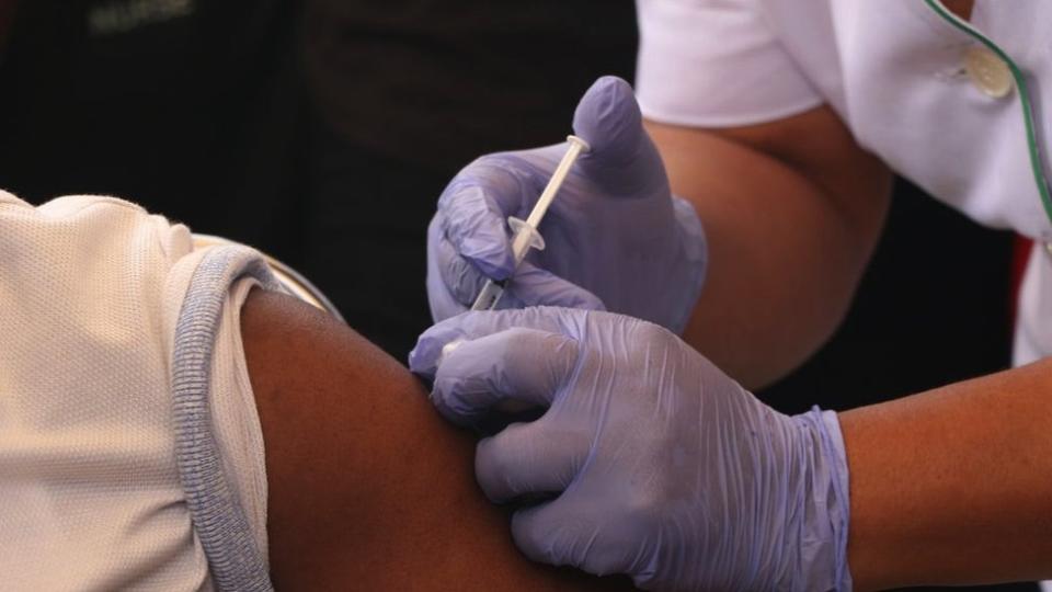 A person receives a dose of the Oxford/AstraZeneca coronavirus disease (COVID-19) at the Cacovid isolation centre, Mainland, Infectious disease hospital, Yaba, in Lagos, Nigeria.