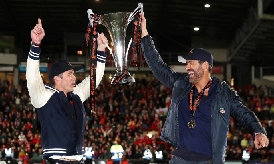 Rob McElhenney and Ryan Reynolds celebrate with the National League trophy won by Wrexham.