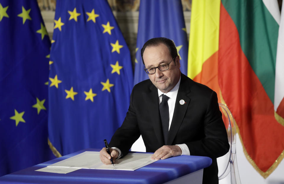 French President Francois Hollande signs a declaration during an EU summit meeting at the Orazi and Curiazi Hall in the Palazzo dei Conservatori in Rome on Saturday, March 25, 2017. European Union leaders were gathering in Rome to mark the 60th anniversary of their founding treaty and chart a way ahead following the decision of Britain to leave the 28-nation bloc. (AP Photo/Alessandra Tarantino)