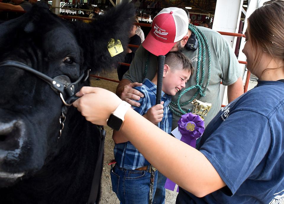 Tom Hawley 2023 feature single picture titled "Tears of Joy" took first place in the Michigan Press Photographer Association. Kody Fitch, 11, of Maybee could not hold back the tears after he won his division 2 medium size steers in the 4-H steer show at the Monroe County Fair Wednesday, August 2, 2023. Held by his father Tobie Fitch and with his sister Jordyn Fitch. Kody is a member of the Barnyard Clovers 4-H in Maybee.