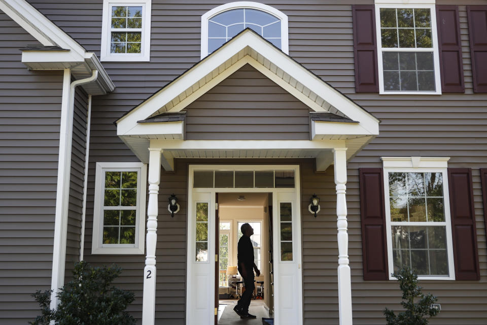 FILE - In this Tuesday, July 21, 2020, file photo, Anil Lilly tours his new home, in Washingtonville, N.Y. The coronavirus pandemic helped shape the housing market by influencing everything from the direction of mortgage rates to the inventory of homes on the market to the types of homes in demand and the desired locations. (AP Photo/John Minchillo, File)