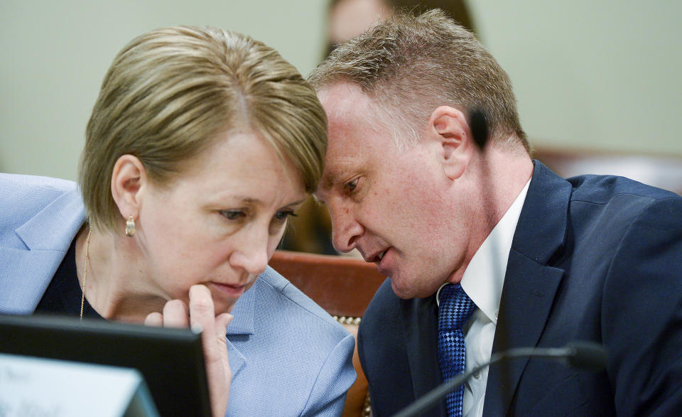 Rep. Craig Hall, R-West Valley City confers with Judiciary chair Rep. Karianne Lisonbee, during the House Judiciary Committee meeting in Salt Lake City, Utah, on Tuesday, March 5, 2019. Hall watched lawmakers dismantle his bill to end conversion therapy and replace it with an alternative that he says would do nothing to stop the widely-discredited practice. (Leah Hogsten/The Salt Lake Tribune via AP)