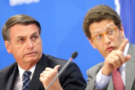 Brazil's President Jair Bolsonaro and Brazil's Environment Minister Ricardo Salles attend a news conference at the Planalto Palace in Brasilia