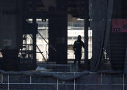 A man works at the construction site of the New National Stadium, main stadium of Tokyo 2020 Olympics and Paralympics, in Tokyo, Japan December 22, 2017. REUTERS/Issei Kato