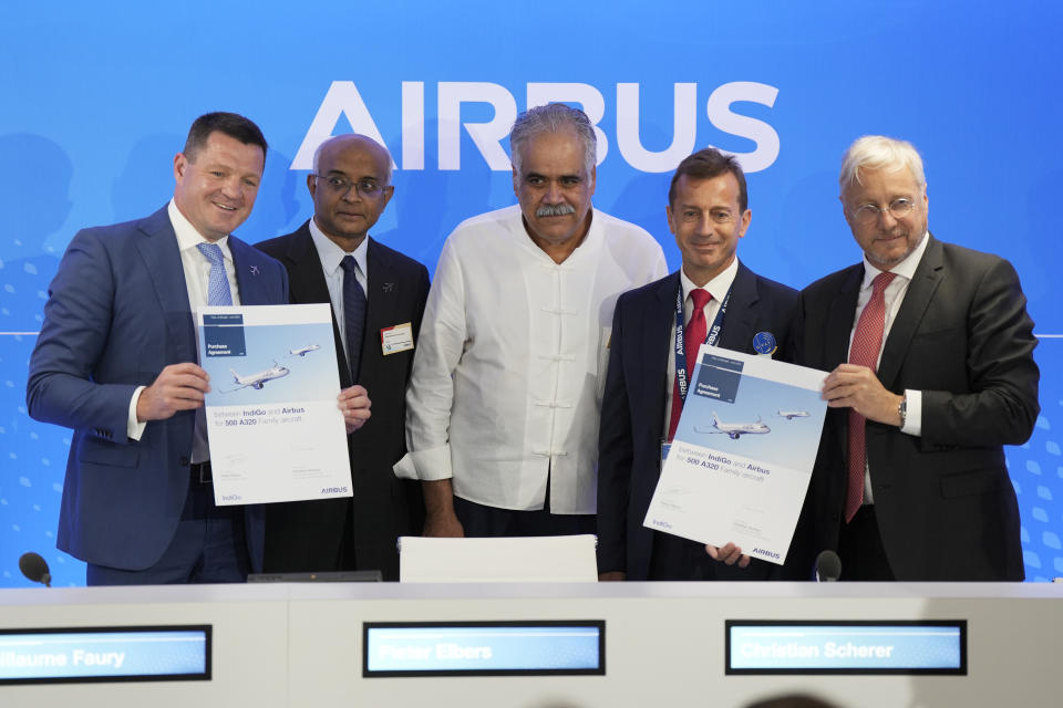 From left: CEO of IndiGo Pieter Elbers, Chairman and Non-Executive Independent Director of IndiGo Dr. Venkataramani Sumantran, Promoter & Managing Director of IndiGo Rahul Bhatia, Airbus CEO Guillaume Faury and Airbus Chief Commercial Officer and Head of International Christian Scherer pose for a picture with signed documents during a news conference during the Paris Air Show in Le Bourget, north of Paris, France, Monday, June 19, 2023. (AP Photo/Lewis Joly)