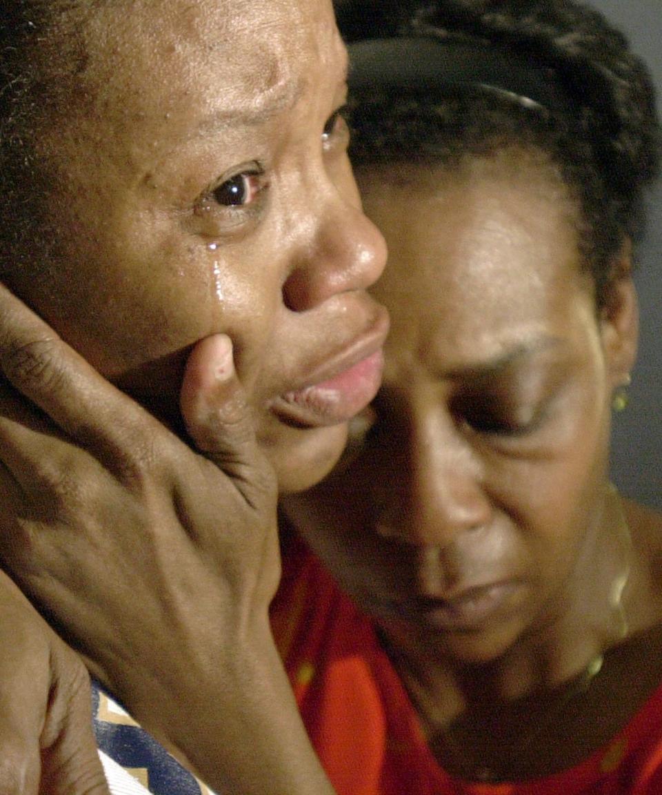 Shelia Smith, left, and Mary Bradley console one another Sunday, July 8, 2001, outside the Chicago apartment of Tracey Bradley, mother of Diamond, 3, and Tionda Bradley, who went missing from their home on the South Side on July 6, 2001.  Smith is Tracey's aunt and Mary Bradley is Tracey's mother and the children's grandmother.