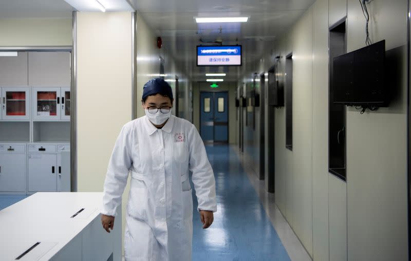 A nurse walks inside finished but still unused building A2 of the Shanghai Public Clinical Center Shanghai, following the outbreak of the new coronavirus, in Shanghai