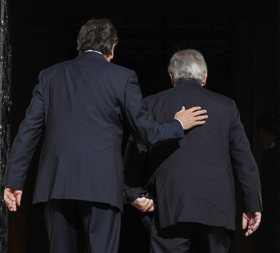 Greek Prime Minister Antonis Samaras, left, leads Jean Claude Junker, Prime Minister, of Luxembourg and President of Eurogroup prior their meeting in Athens, on Wendesday, Aug. 22, 2012. Greece needs more time to implement tough financial reforms and spending cuts, Prime Minister Antonis Samaras says as he starts the first of a series of top-level European meetings to discuss his debt-ridden country's international bailout. Jean-Claude Juncker, head of the Eurogroup, the body representing the finance ministers of the 17 countries that use the euro, arrived in Athens Wednesday afternoon to meet with Samaras and his finance minister, Yannis Stournaras. (AP Photo/Petros Giannakouris)