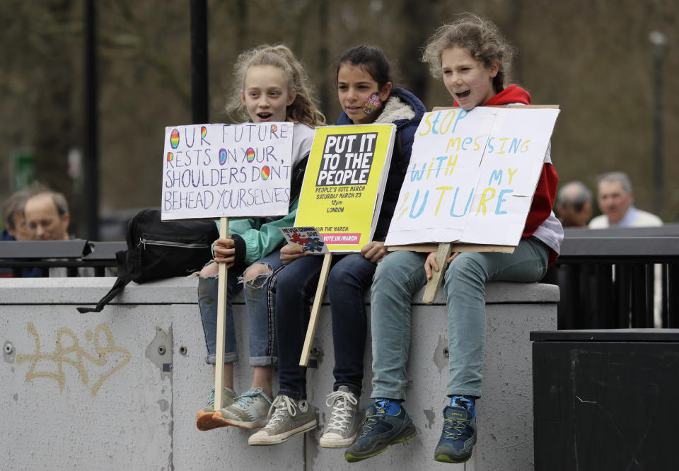 Children wait for the start of a Peoples Vote anti-Brexit march in London, Saturday, March 23, 2019. The march, organized by the People's Vote campaign is calling for a final vote on any proposed Brexit deal. This week the EU has granted Britain's Prime Minister Theresa May a delay to the Brexit process. (AP Photo/Kirsty Wigglesworth)