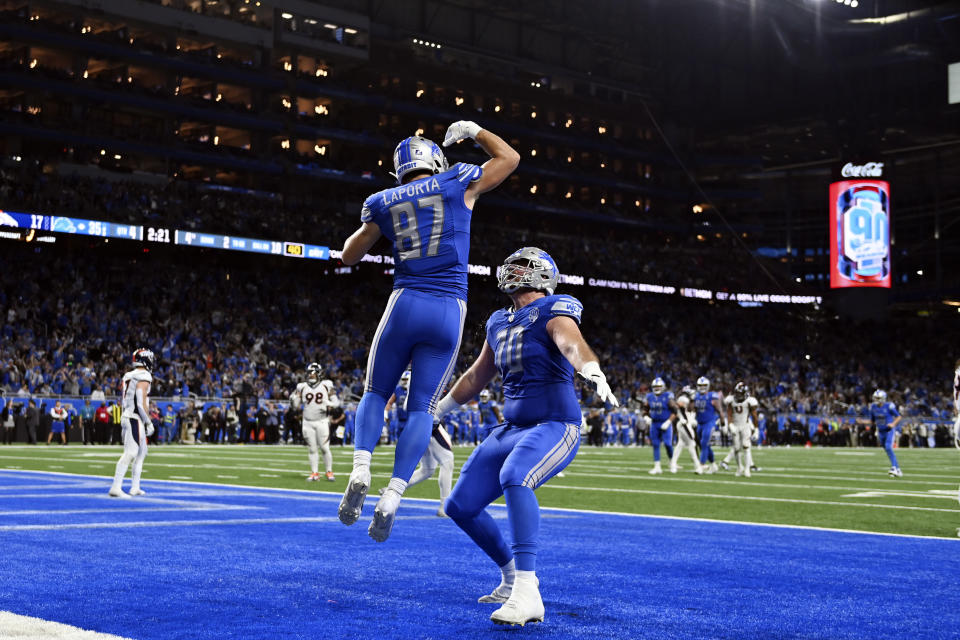 Detroit Lions tight end Sam LaPorta (87) celebrates his10-yard reception for a touchdown with teammate offensive tackle Dan Skipper (70) during the second half of an NFL football game against the Denver Broncos, Saturday, Dec. 16, 2023, in Detroit. (AP Photo/David Dermer)
