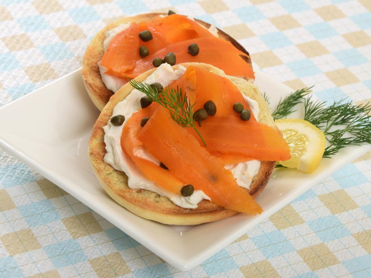 A purely vegan take on a classic breakfast food - marinated carrot slices with the look of smoked salmon on a bagel spread with vegan almond milk cream cheese.