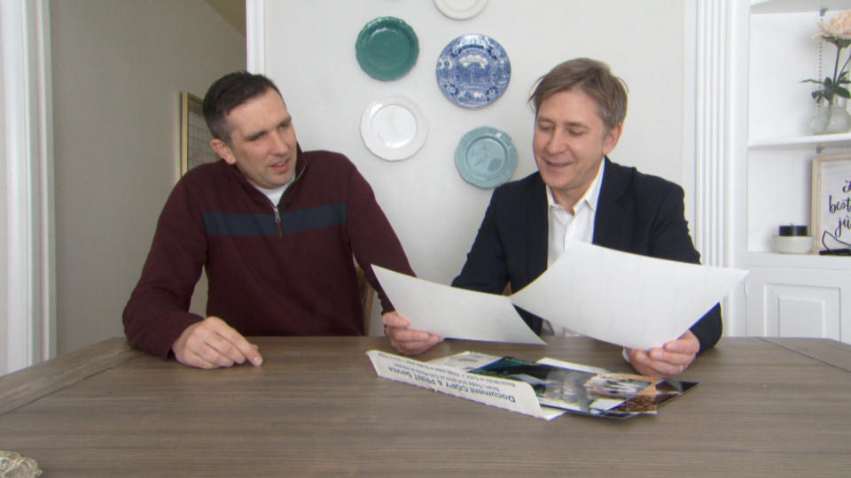 Ben Taylor shows Steve Hartman the original photos that Joel took for him. (Photo: CBS Evening News)