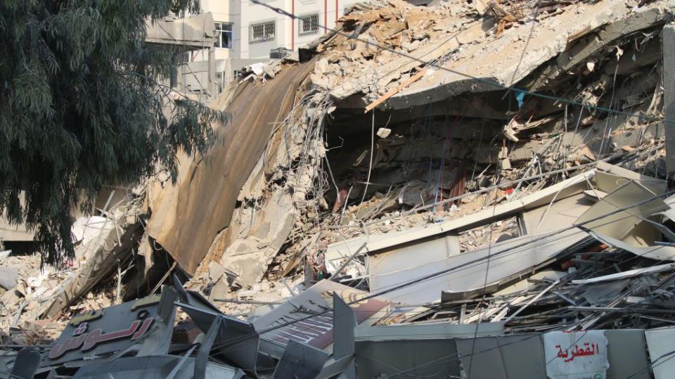 Palestinian citizens inspect damage to their homes caused by Israeli airstrikes on Sunday in Gaza City, Gaza.