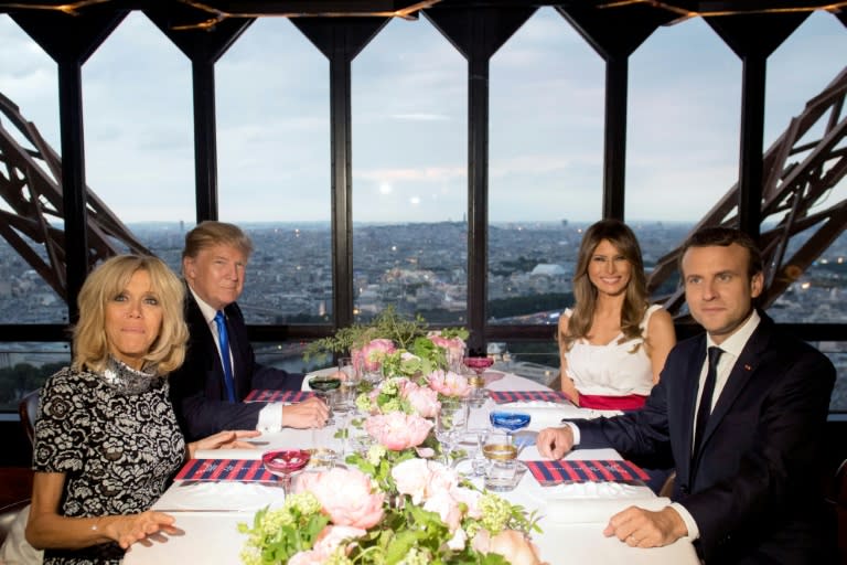 French President Emmanuel Macron (R), his wife Brigitte Macron (L), US President Donald Trump (2nd L) and First Lady Melania Trump (2nd R) dine at the prestigious Le Jules Verne Restaurant on the Eiffel Tower in Paris