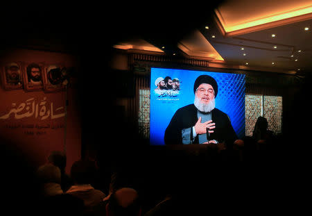 Lebanon's Hezbollah leader Sayyed Hassan Nasrallah addresses his supporters through a screen during a rally commemorating the annual Hezbollah Martyrs' Leaders Day in Jebshit village, southern Lebanon February 16, 2017. REUTERS/Ali Hashisho