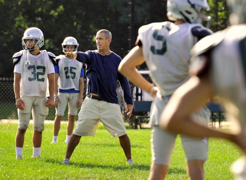 Duxbury High School's new head football coach Matt Landolfi instructs his team during practice on Monday, Aug. 30, 2021.