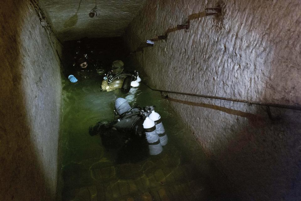 German, Hungarian and Lithuanian divers are getting ready for a joint dive into the flooded passages of a former limestone mine in Budapest, Hungary, Friday, Oct. 13, 2023, during an international training exercise which prepares military divers to find and remove unexploded underwater ordnances. Hungary this year hosted the 10-day exercise for the second year in a row and provided the soldiers from Hungary, Germany, Belgium and Lithuania with hands-on training in a variety of environments, like facing the powerful current of the Danube River. (AP Photo/Bela Szandelszky)