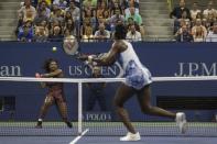 Serena Williams of the U.S. (L) returns a shot to her sister and compatriot Venus Williams during their quarterfinals match at the U.S. Open Championships tennis tournament in New York, September 8, 2015. REUTERS/Adrees Latif